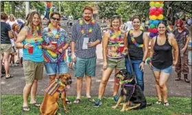  ??  ?? A group of friends, along with their four-legged pals, enjoy the Pride Festival.