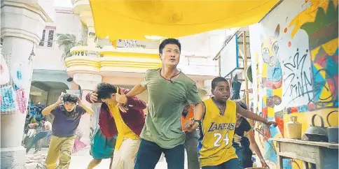  ??  ?? Wu Jing in a evacuation scene from ‘Wolf Warriors 2’.