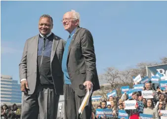  ?? SCOTT OLSON/GETTY IMAGES ?? The Rev. Jesse Jackson stands with Sen. Bernie Sanders on Sunday at a rally in Calder Plaza in Grand Rapids, Michigan.