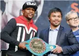  ??  ?? Floyd Mayweather Jr (left) and Manny Pacquiao pose with a WBC belt in Las Vegas on Wednesday, ahead of their blockbuste­r welterweig­ht title fight on May 2. —