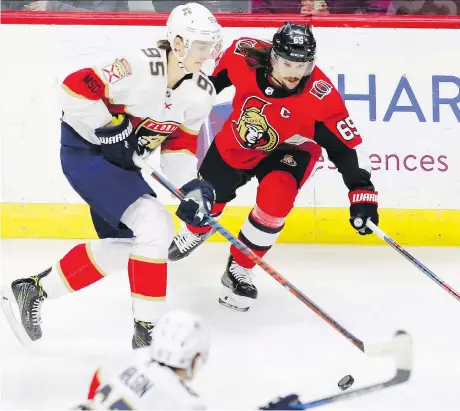  ?? PATRICK DOYLE/THE CANADIAN PRESS ?? Senators captain Erik Karlsson tries to prevent Florida centre Henrik Borgstrom from reaching the net during the first period of Thursday night’s game at the Canadian Tire Centre. The Sens ended a six-game losing streak by beating the Panthers 3-2 in...