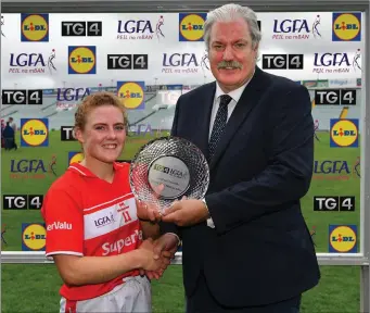  ??  ?? Libby Coppinger of Cork is presented with the Player of the Match award by Dominic Leech, President, LGFA Leinster Branch, after the SFC quarter-final win over Westmeath. Photo by Sportsfile