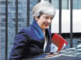  ?? Frank Augstein ?? The Associated Press Britain’s Prime Minister Theresa May leaves 10 Downing Street on Wednesday to attend Parliament’s weekly Prime Ministers’ Questions session.