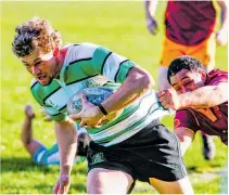  ?? Photo / Lewis Gardner ?? Marist’s double try scorer Luke Foster has Kaierau No 8 Nathan Puketapu clinging on desperatel­y.