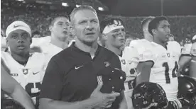  ?? SUE OGROCKI/ASSOCIATED PRESS ?? Army coach Jeff Monken stands with his team after falling to Oklahoma in OT. The No. 22 Black Knights are ranked in the Associated Press Top 25 poll for the first time since 1996.