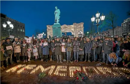  ?? PHOTO: AP ?? Protesters in Moscow’s Pushkin Square stand in front of the word Kemerovo, made up of candles, to commemorat­e the victims of the shopping mall fire.