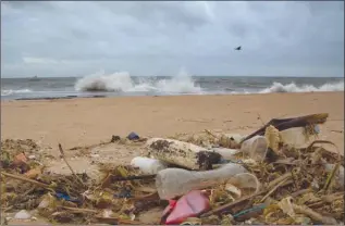  ?? The Associated Press ?? A plastic bottle lies among other debris washed ashore on the Indian Ocean beach in Uswetakeiy­awa, north of Colombo, Sri Lanka. Secretary-General Antonio Guterres on Monday opened the first-ever U.N. conference on oceans with a warning that discarded...