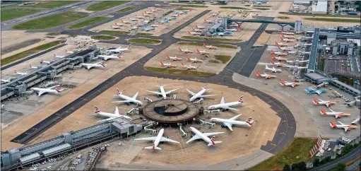  ??  ?? GROUNDED: British Airways and easyJet planes sit empty at Gatwick Airport. Airline bosses are now planning legal action to get fleets flying again