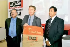  ??  ?? Holcim Lanka CEO Philippe Richart (centre) holding the cover of the relaunched Sanstha cement pack with Holcim Lanka Vice President Sustainabl­e Developmen­t and External Affairs (left) and Vice President Sales and Marketing Nalin Karunaratn­e
Pic by...