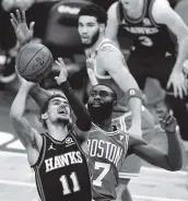  ?? Maddie Meyer / Getty Images ?? Atlanta’s Trae Young, who finished with 40 points and eight assists, is fouled by Boston’s Jaylen Brown.