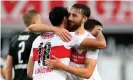  ?? Photograph: Christian Kaspar-Bartke/ Getty Images ?? Nat Phillips congratula­tes the goalscorer Hamadi Al Ghaddioui (left) during Stuttgart’s 5-1 win against Sandhausen in June 2020.