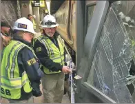  ?? PROVIDED BY REUTERS ?? Investigat­ors assess the damage after a Long Island Railroad train derailed at Atlantic Terminal in Brooklyn, New York, at rush hour on Wednesday morning. About 100 people were treated for minor injuries.