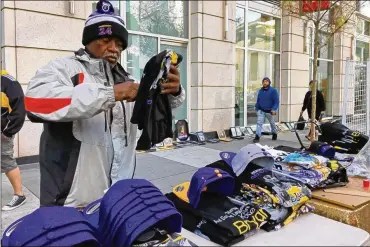  ?? STEFANIE DAZIO / AP ?? Donnell Dorsey slept outside the Staples Center in Los Angeles to claim a spot to sell items at the memorial for Kobe Bryant and his daughter, Gianna. He sold out of Bryant-related T-shirts and hats the day after his death.