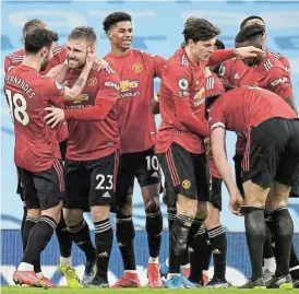  ?? /Peter Powell/Getty Images ?? Red all over: Luke Shaw celebrates scoring United’s second goal with Bruno Fernandes, Marcus Rashford and teammates.