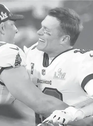  ?? FILE ?? Bucs quarterbac­k Tom Brady and tight end Rob Gronkowski celebrate after winning Super Bowl LV against the Kansas City Chiefs last year.