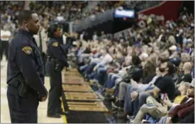  ?? TONY DEJAK — THE ASSOCIATED PRESS ?? A Cleveland policeman stands watch during a game between the Utah Jazz and the Cleveland Cavaliers, in Cleveland. The city of Cleveland is discussing the creation of a pilot program to test the feasibilit­y of Cleveland police officers wearing body...