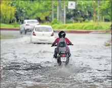  ?? SUNIL GHOSH /HT ?? Motorists make their way through a waterlogge­d stretch in Noida’s Sector 44. The city recorded 35mm of rainfall between 8.30am and 5.30pm on Wednesday.