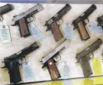  ?? | SETH PERLMAN/AP ?? Guns for sale at Capitol City Arms Supply in Springfiel­d on Wednesday.