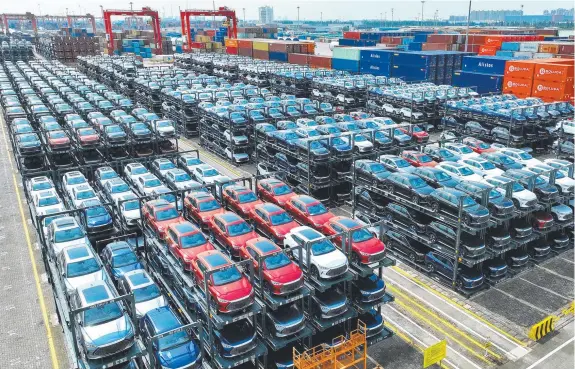  ?? ?? BYD electric vehicles waiting to be loaded on a ship are stacked at the internatio­nal container terminal of Taicang Port at Suzhou Port, China.