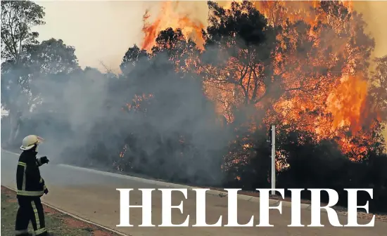  ?? Picture: FREDLIN ADRIAAN ?? TAKING HEAT: A firefighte­r backs off from the heat, at Woodridge College, between Jeffreys Bay and Port Elizabeth. The school was evacuated due to smoke, an official said