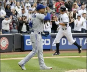  ?? BILL KOSTROUN — THE ASSOCIATED PRESS ?? Toronto pitcher Marcus Stroman reacts as the Yankees’ Aaron Judge, right, rounds the bases after hitting a home run during the fourth inning Saturday at Yankee Stadium in New York.