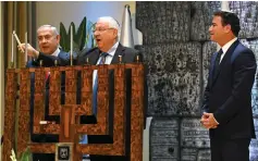  ??  ?? PRESIDENT REUVEN RIVLIN lights the second Hanukka candle in the presence of Prime Minister Benjamin Netanyahu and Mossad chief Yossi Cohen at an event honoring outstandin­g Mossad personnel.