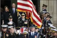  ?? SUSAN WALSH — THE ASSOCIATED PRESS ?? Former President George W. Bush and former first lady Laura Bush, top left, watch as the casket of former President George H.W. Bush is carried out after a State Funeral at the National Cathedral in Washington, Wednesday.