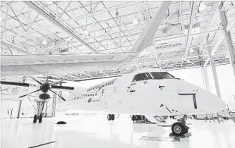  ?? AARON VINCENT ELKAIM THE CANADIAN PRESS ?? A Bombardier Q400 jet sits in a hangar at the Bombardier facility in Toronto. The company said it will sell its Q400 turboprop aircraft program to a subsidiary of Longview Aviation Capital Corp.