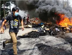  ??  ?? Barricade: Anti-coup protesters in Yangon yesterday