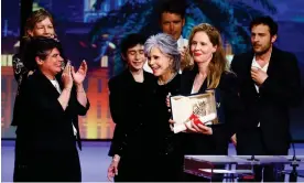  ?? Justine Triet picks up her Palme d'Or from Jane Fonda. Photograph: Eric Gaillard/Reuters ??