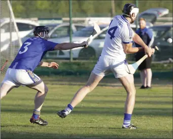  ??  ?? Andy Walsh of Eire Og Greystones takes aim at the posts as Gerry Connors closes in.