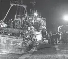  ?? ?? Police check a boat Saturday in the southern Italian port of Crotone. Italy’s coast guard said it rescued more than 1,000 migrants off the country’s southern mainland in recent days.