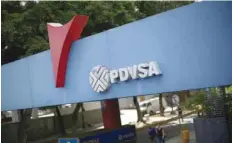  ?? — Reuters ?? The corporate logo of the state oil company PDVSA is seen at a gas station in Caracas.