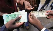  ??  ?? ZIMBABWE until now has been using multiple currencies, including the rand, US dollar and Botswana pula, since 2009, when hyperinfla­tion forced it to abandon its currency. | AP