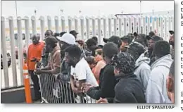  ?? ELLIOT SPAGAT/AP ?? Migrants in Tijuana, Mexico, many from Cameroon, listen to names being called for those who can claim asylum in the US.
