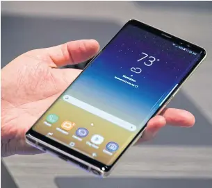  ?? AFP ?? A guest holds the new Galaxy Note 8 ‘phablet’ during a launch event in New York on Wednesday.