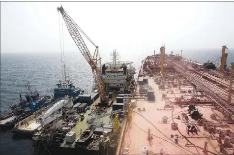  ?? (File Photo/AP/Osamah Abdulrahma­n) ?? Technical vessels are seen June 12 near the decrepit Safer tanker off the coast of Yemen.