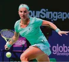  ?? AFP ?? Svetlana Kuznetsova hits a return against Agnieszka Radwanska during their singles match in Singapore yesterday.