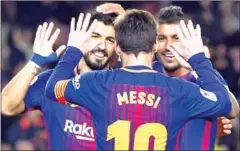  ?? AFP ?? Barcelona’s Paulinho (right) celebrates a goal with Lionel Messi and Luis Suarez (left) in their La Liga match with Levante on Sunday.