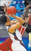  ?? Michael Conroy The Associated Press ?? Gonzaga’s Jalen Suggs charges into Oklahoma’s Kur Kuath in the first half of the Bulldogs’ 87-71 win Monday in the NCAA Tournament in Indianapol­is.