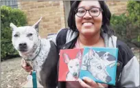  ?? Associated Press ?? Danielle Moore with her dog, Kana, in March, holding paintings of the Australian cattle dog in Dallas. In the dog-eat-dog world of online shopping, Chewy has an unusual plan to fend off Amazon: turning pets into works of art. The online pet shop surprises customers with oil paintings of their furry friends, a move the company says wins them customers for life.