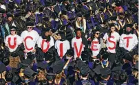  ?? JESSICA CHRISTIAN / SAN FRANCISCO CHRONICLE / AP ?? UC Berkeley Law School graduates wear T-shirts that read “UC DIVEST” as a form of protest during the UC Berkeley Law School commenceme­nt at the Greek Theater in Berkeley, Calif., on Friday.