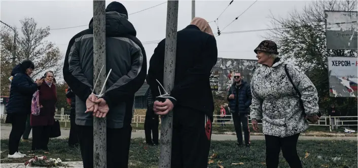  ?? ?? Rounded up: Two suspected collaborat­ors are tied by the hands in Kherson yesterday after being detained when Ukrainian troops recaptured the city