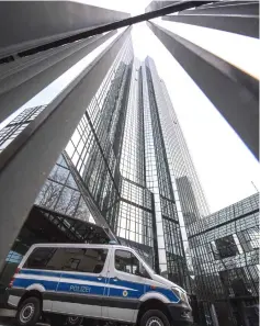  ??  ?? A police vehicle is parked at Deutsche Bank’s headquarte­rs in Frankfurt. — AFP photo