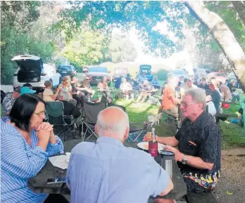  ??  ?? Tanners Point locals enjoy a barbecue and shared picnic dinner on the reserve last Saturday.