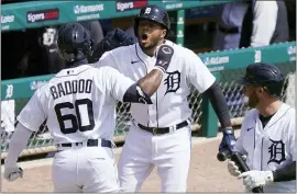  ?? CARLOS OSORIO — THE ASSOCIATED PRESS ?? Detroit Tigers’ Akil Baddoo, left, is greeted by Jeimer Candelario after hitting a solo home run in his first Major League at-bat Sunday.