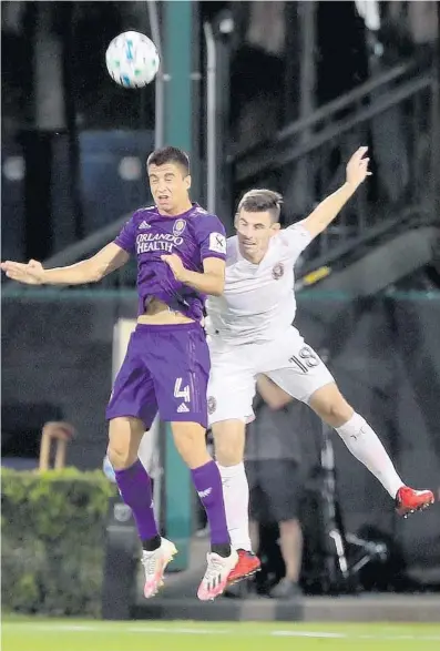  ?? STEPHEN M. DOWELL/ORLANDO SENTINEL ?? Orlando’s Joao Moutinho, left, and Miami’s Dylan Nealiscoll­ide during Wednesday’s match at Disney’s ESPN Wide World of Sports.