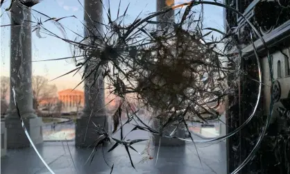  ??  ?? A window at the US Capitol building broken by supporters of US President Donald Trump. Photograph: Dmitry Kirsanov/TASS