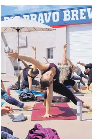  ??  ?? The latest trend in yoga is drinking beer during class. Mobile yoga studio YogaZo hosts Pints & Planks classes at local breweries, such as this one at Rio Bravo Brewing Company.