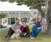  ??  ?? Michael Bayly, Michaela Bayly, Donna Alley, and Poochini the cavoodle, outside the home built by Munro.
The vintage, arts and crafts gate shows Munro’s influences and training under Cecil Woods.
